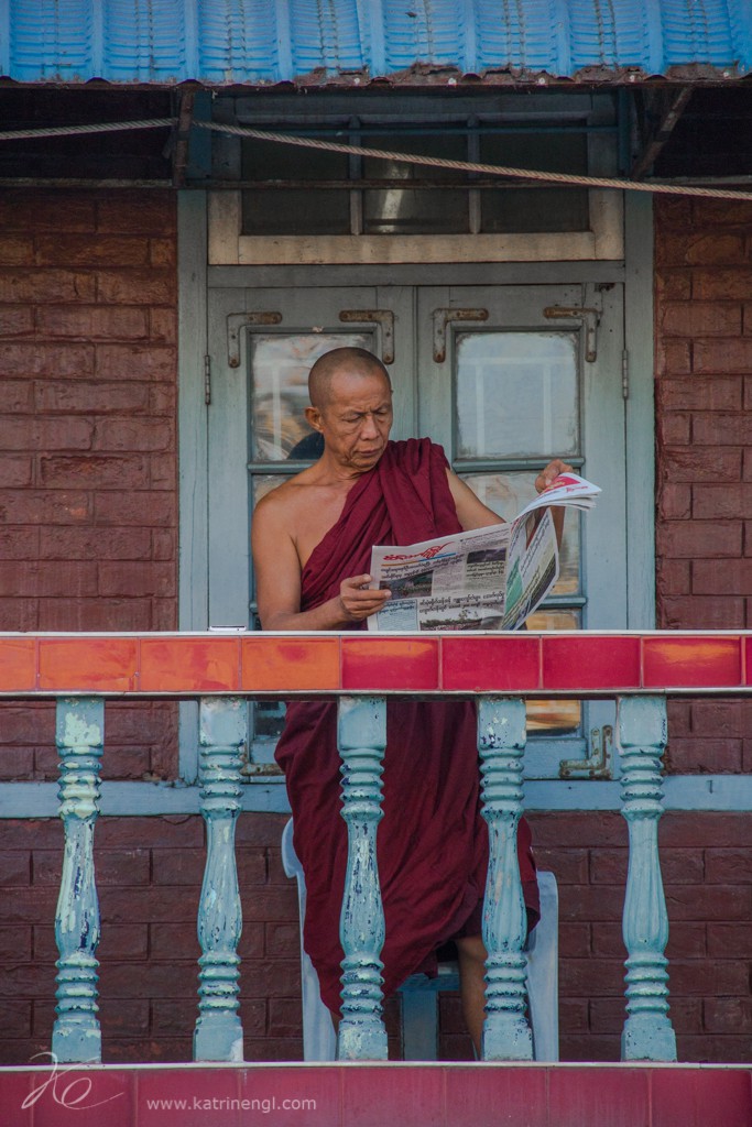 Reading monk on balcony Yangon